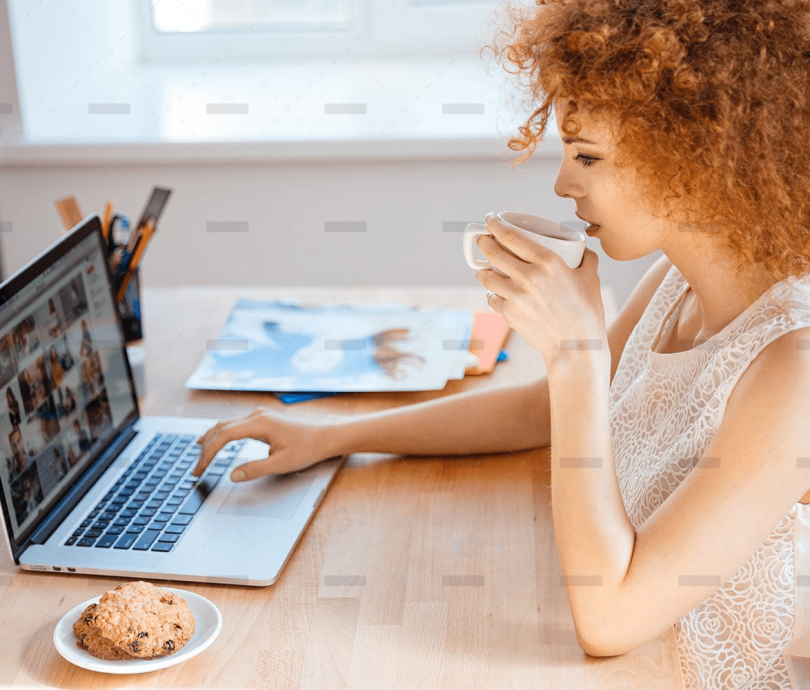 demo-attachment-493-woman-photographer-drinking-coffee-and-working-PJNBP6U